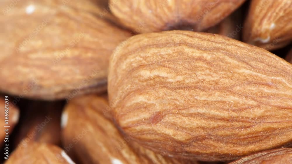 Dried almond nuts close-up with the effect of scaling