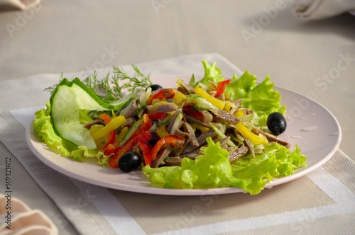salad with tongue, vegetables and fresh greens