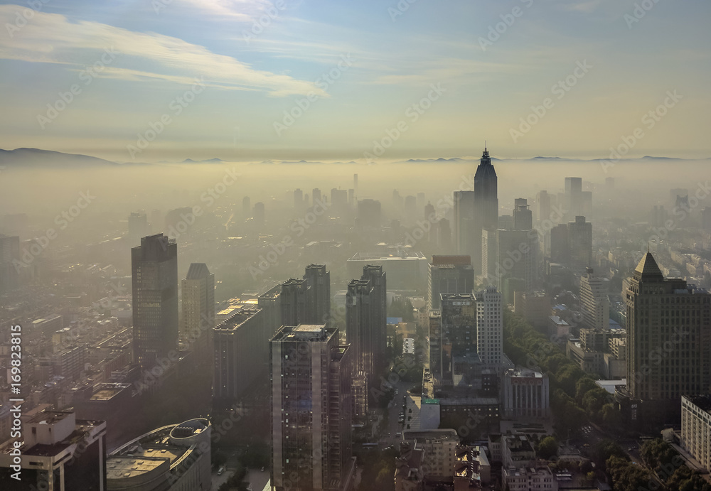 Nanjing city with sunrise and morning mist from high angle.