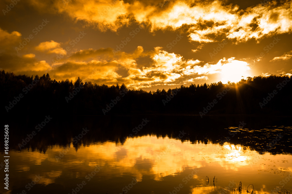 Landscape of autumn, sunset sky over lake in the forest, silhouette