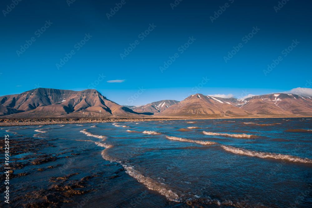 Landscape of a nature of a pink sunset with clouds in the mountains of Spitsbergen Svalbard near the Norwegian city Longyearbyen