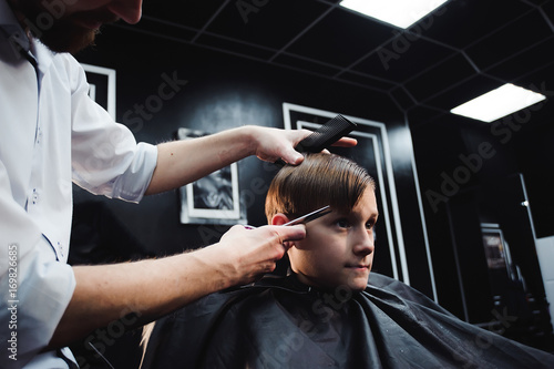 cute young boy getting a haircut