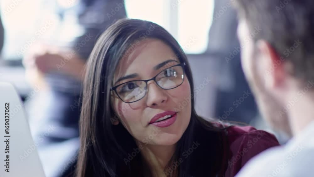 Tracking slow mo of beautiful brunette businesswoman in eyeglasses talking with colleague Tracking slow mo of beautiful brunette businesswoman in eyeglasses talking with colleague