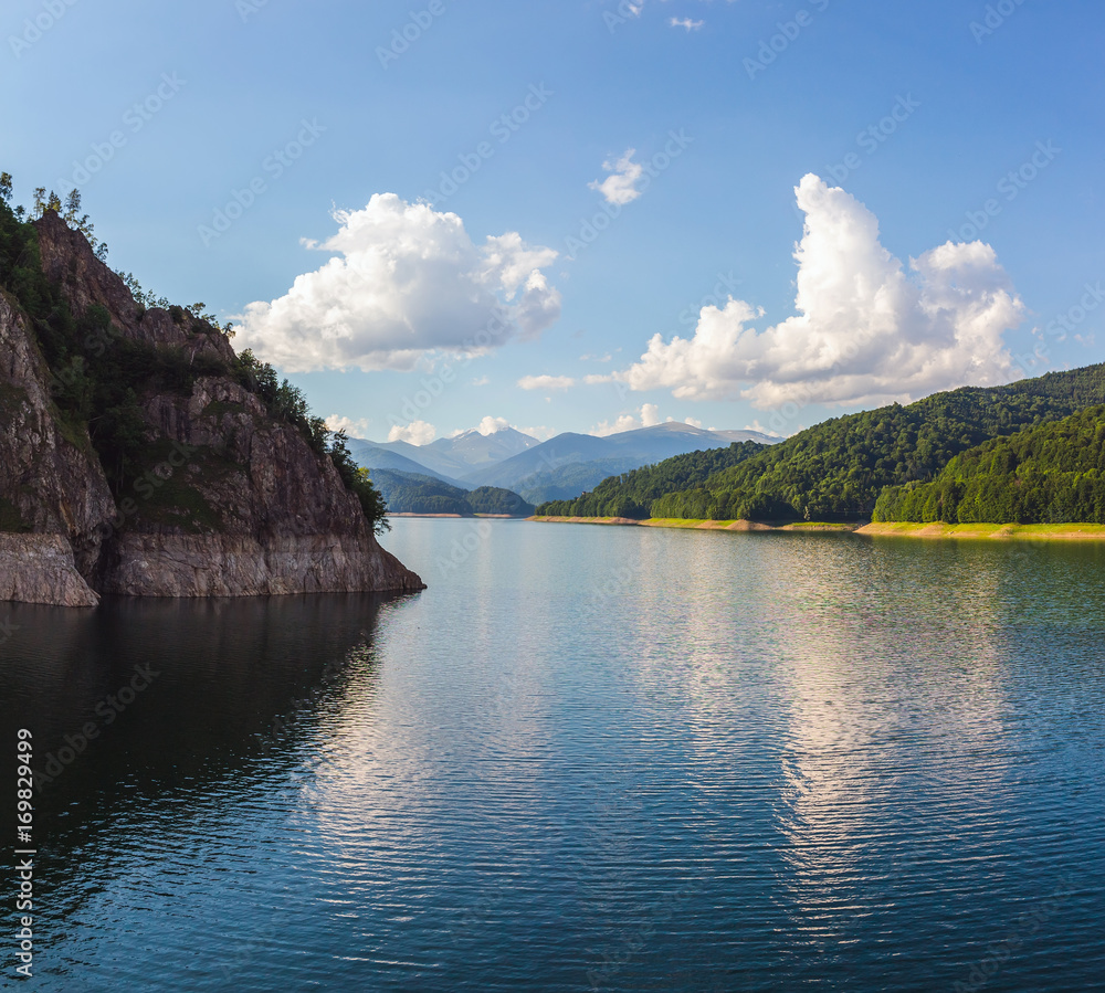 Amazing mountain lake Vidraru in Carpathian mountains at Romania, wild nature landscape in the summer