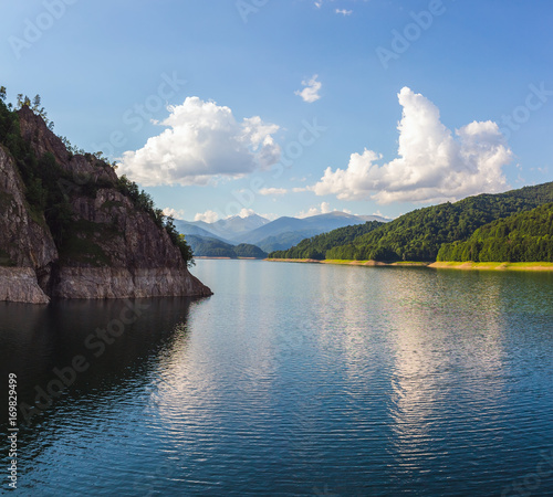 Amazing mountain lake Vidraru in Carpathian mountains at Romania, wild nature landscape in the summer