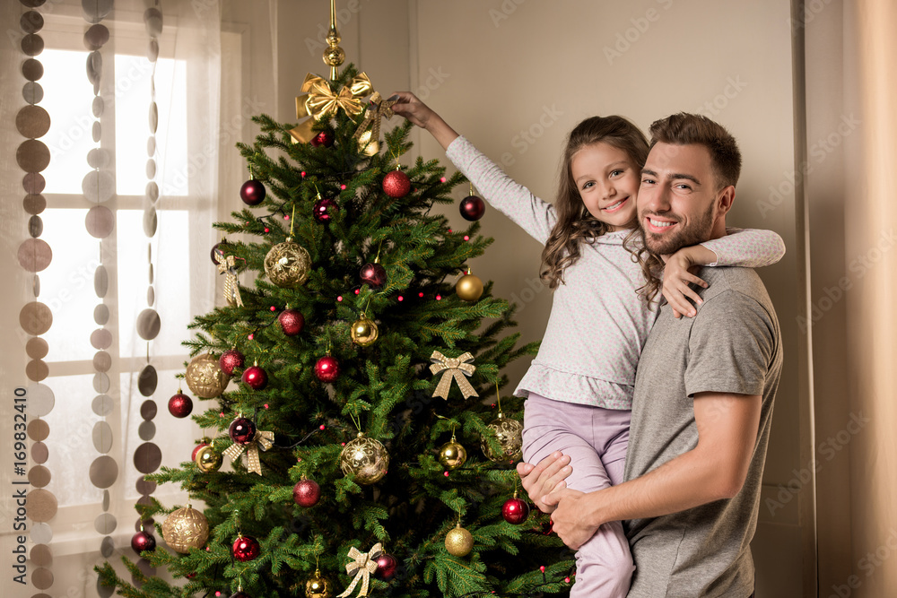 family preparing christmas tree