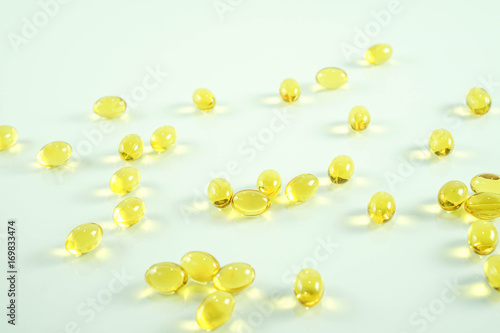 Wallpaper Mural Fish oil capsule, yellow soft gels capsules, Yellow oil pills on white background Torontodigital.ca