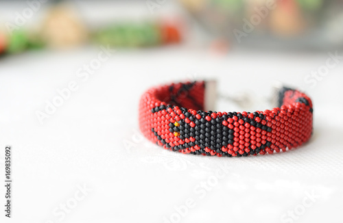 Halloween red bracelet with the image of black spider close up