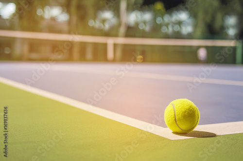 Tennis ball at the hard court corner line © pairhandmade