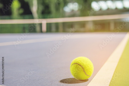 Tennis ball at the hard court line © pairhandmade