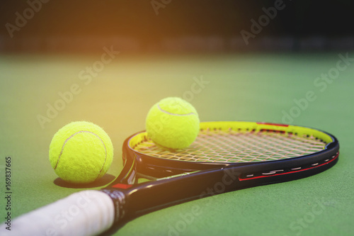 Tennis racket with balls on court © pairhandmade