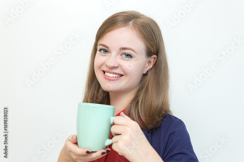Young caucasian girl with a cup of some drink
