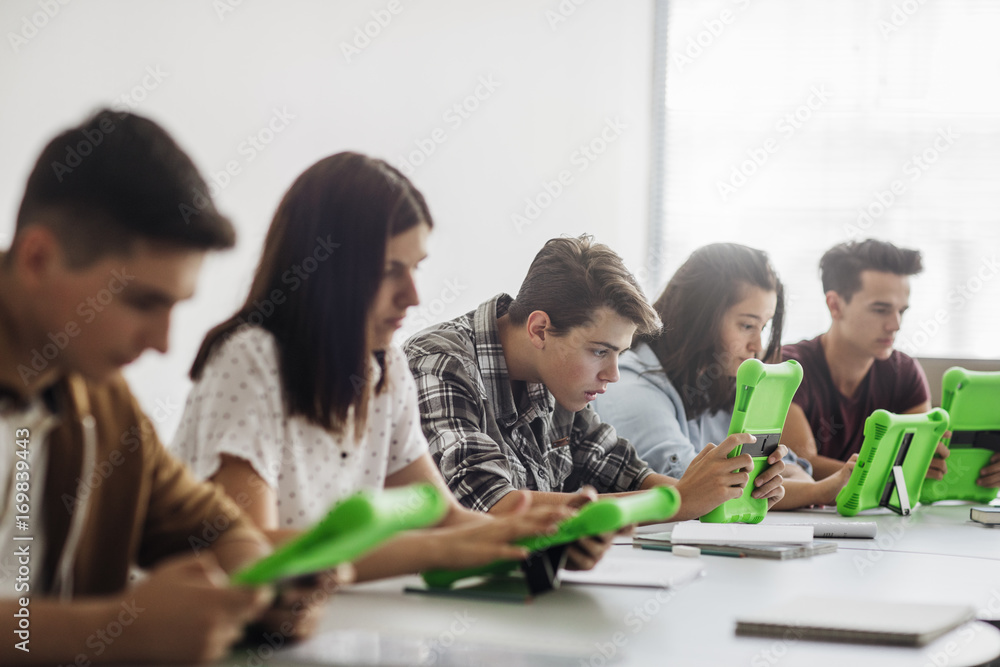 High School Students Using Tablets in Round Classroom High School Students Using Tablets in Round Classroom