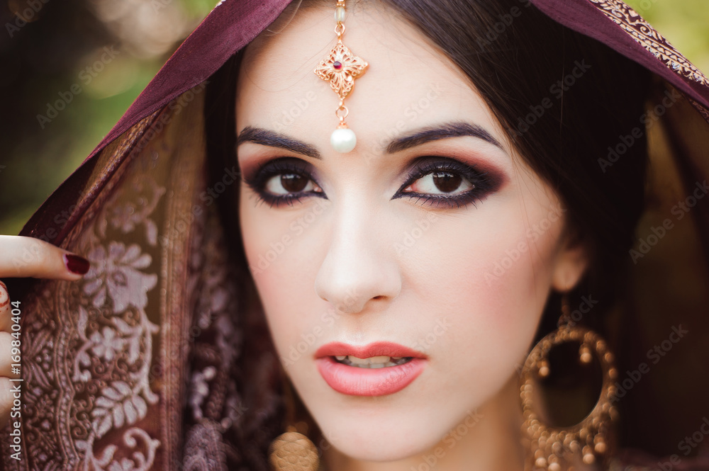 Portrait of beautiful indian girl . Young hindu woman model with tatoo mehndi and kundan jewelry. Portrait of beautiful indian girl . Young hindu woman model with tatoo mehndi and kundan jewelry.