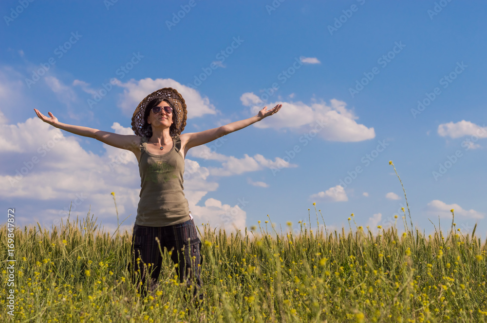 Young woman with hat enjoying the nature. Freedom concept. Young woman with hat enjoying the nature. Freedom concept.