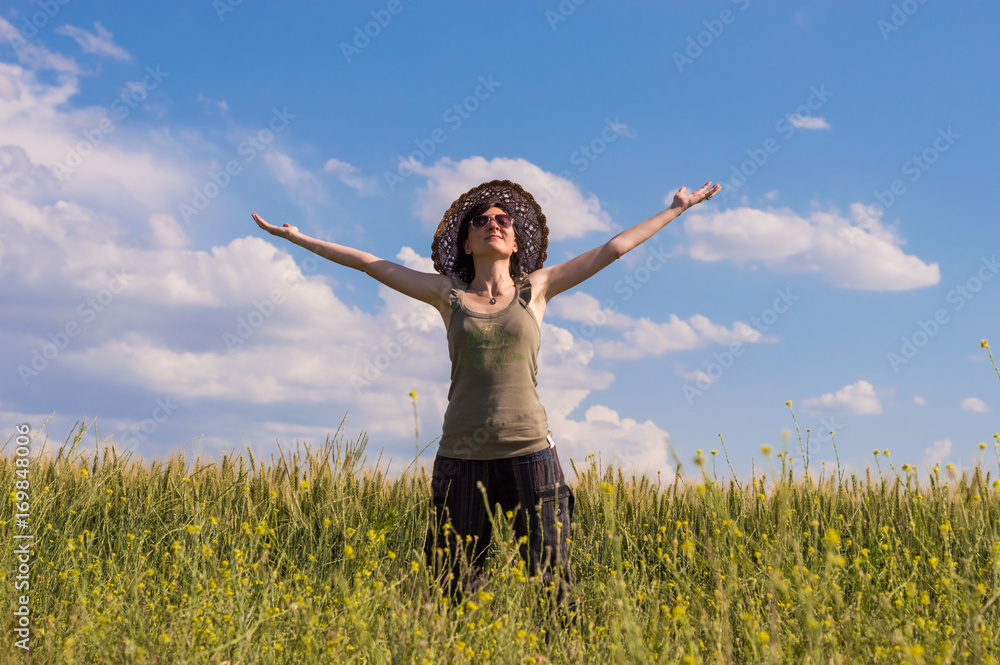 Young woman with hat enjoying the nature. Freedom concept. Young woman with hat enjoying the nature. Freedom concept.