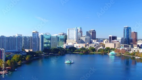 Orlando FL aerial Orlando Lake Eola in the morning with urban skyscrapers and clear blue sky trees