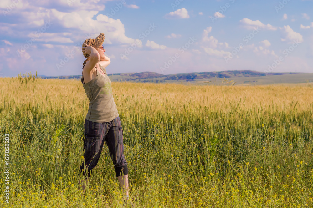 Young woman with hat enjoying the nature. Freedom concept. Young woman with hat enjoying the nature. Freedom concept.