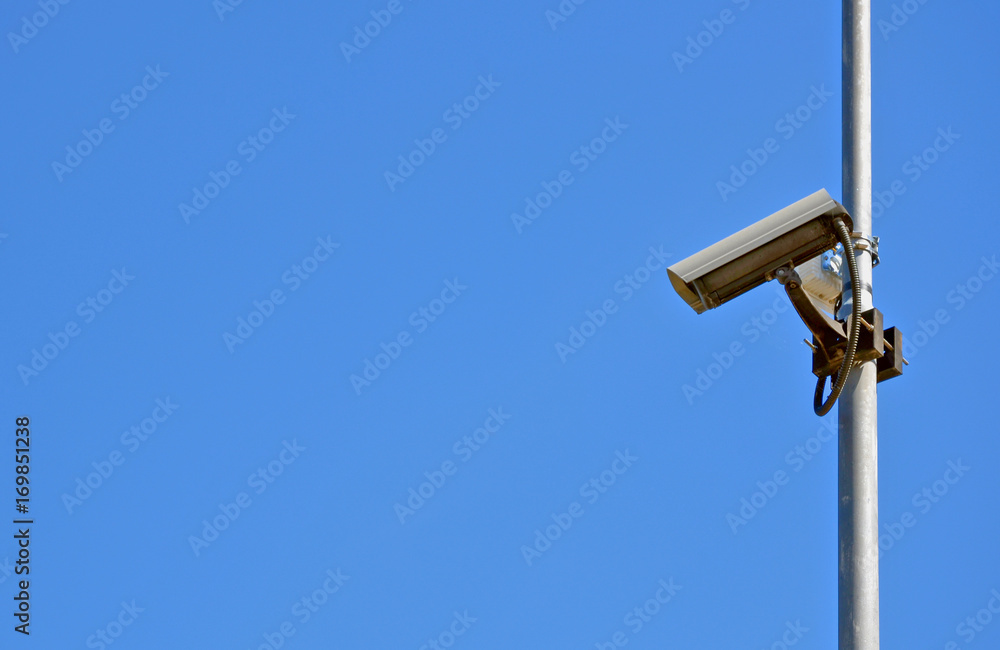 Surveillance camera on the right and blue sky close up Surveillance camera on the right and blue sky close up