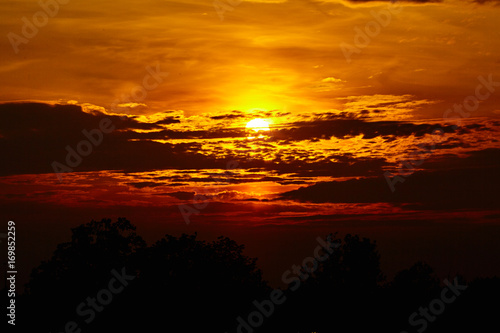 colorful dramatic sky with cloud at sunset. Golden sky background © EwaStudio
