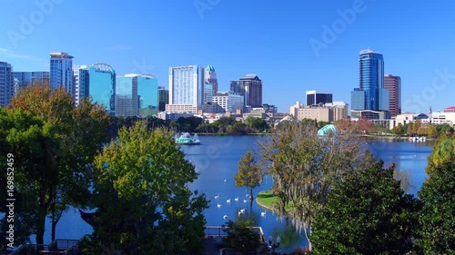 Orlando FL aerial Orlando Lake Eola in the morning with urban skyscrapers and clear blue sky trees