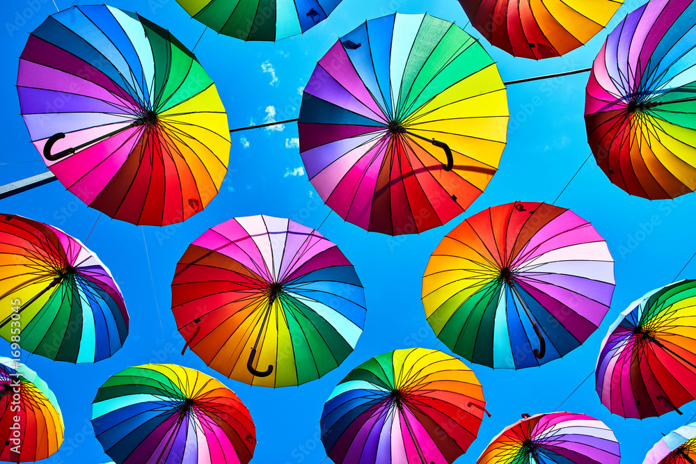 Rainbow umbrella on sky background. Many colorful umbrellas. umbrella street decoration Rainbow umbrella on sky background. Many colorful umbrellas. umbrella street decoration