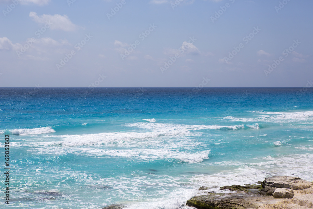 View to the sea from high above big cliffs. The Caribbean ocean and turquoise waters with horizon line.