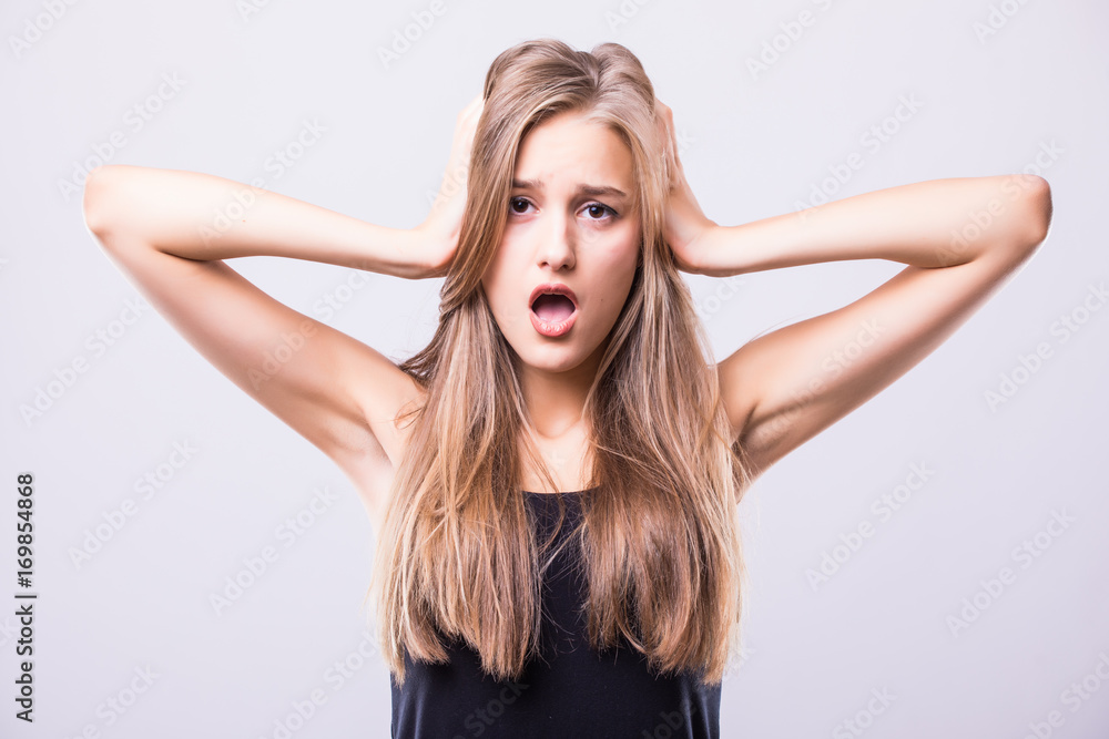 Portrait of shocked woman with mouth open looking away isolated on a gray background Portrait of shocked woman with mouth open looking away isolated on a gray background