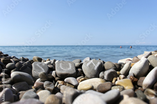 the inscription on the stones the sun on the sea