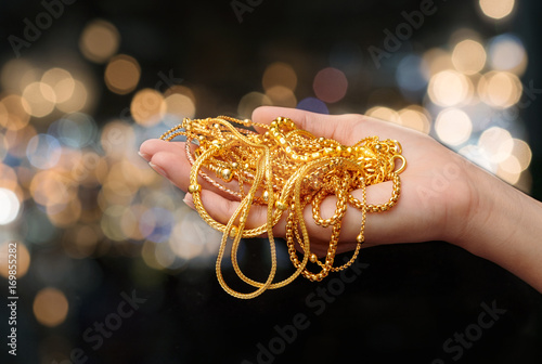 woman hand hold gold bracel...