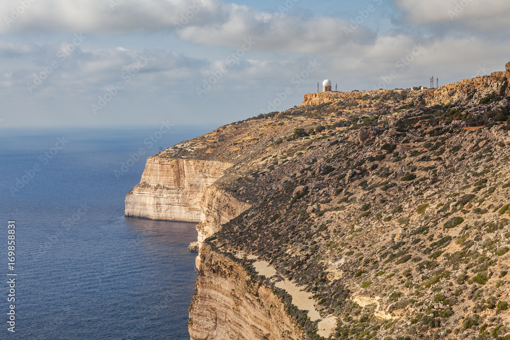 Limestone cliff of Southern shore of Malta island. Summer sunny day. Panoramic seascape.