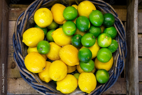 Rustic wicker basket with lemons and limes from above.