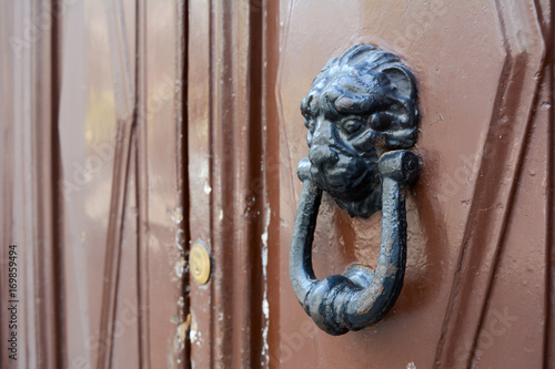 ancient clapper on an ancient door