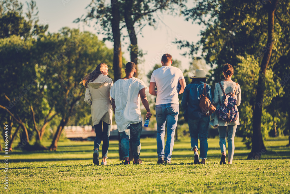 Multi-ethnic group of friends in a park Multi-ethnic group of friends in a park