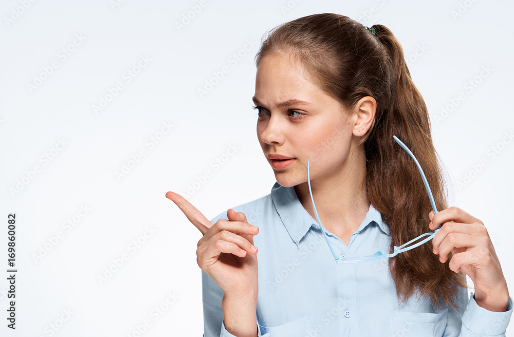 woman holds glasses and points to empty space woman holds glasses and points to empty space