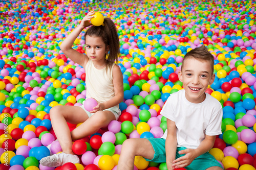 Boy and girl playing in colorful balls