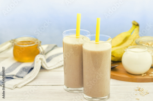 Banana smoothie. Milkshake with banana, honey and oatmeal. Oat smoothies. Healthy breakfast. Picture with space for text or logos