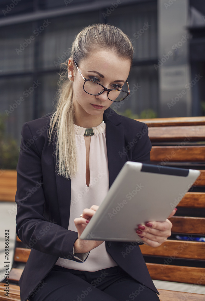 business woman or teacher looking at the tablet business woman or teacher looking at the tablet
