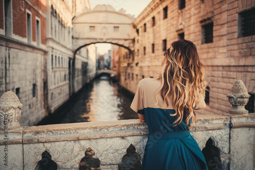 Woman in front of Bridge of Sighs in Venice