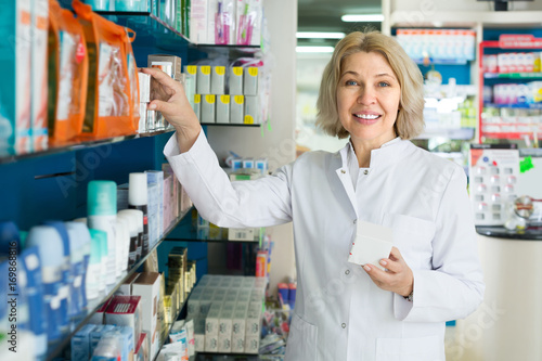 Portrait of two pharmacists working in modern farmacy photo