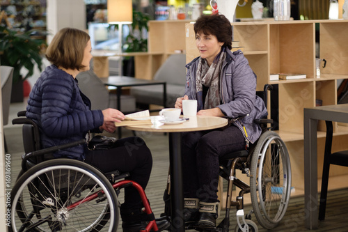 Two physically challenged women in a cafe