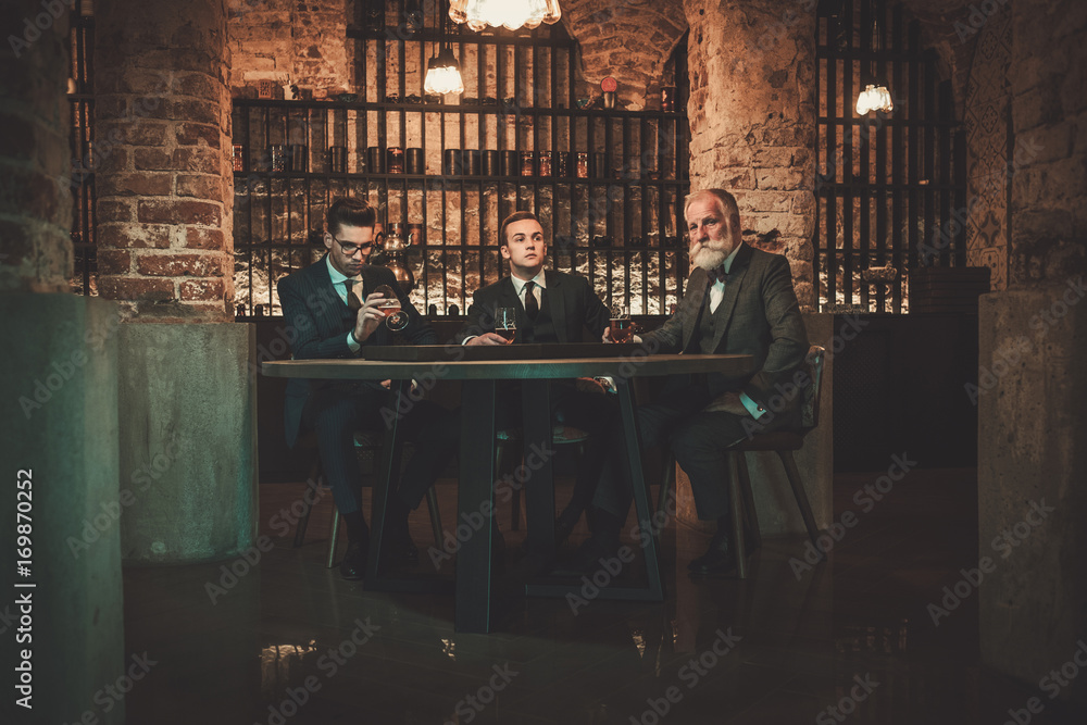 Senior and young gentlemen tasting craft beer Senior and young gentlemen tasting craft beer