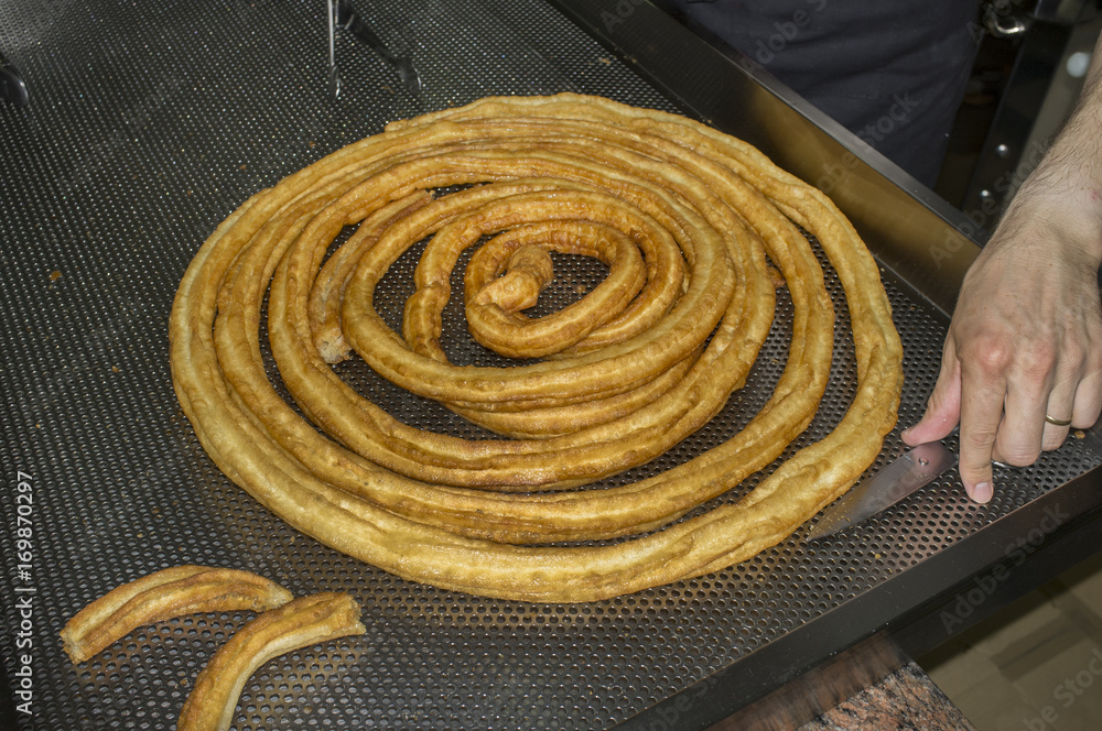 Churros preparation. Cutting the wheel Stock Photo | Adobe Stock