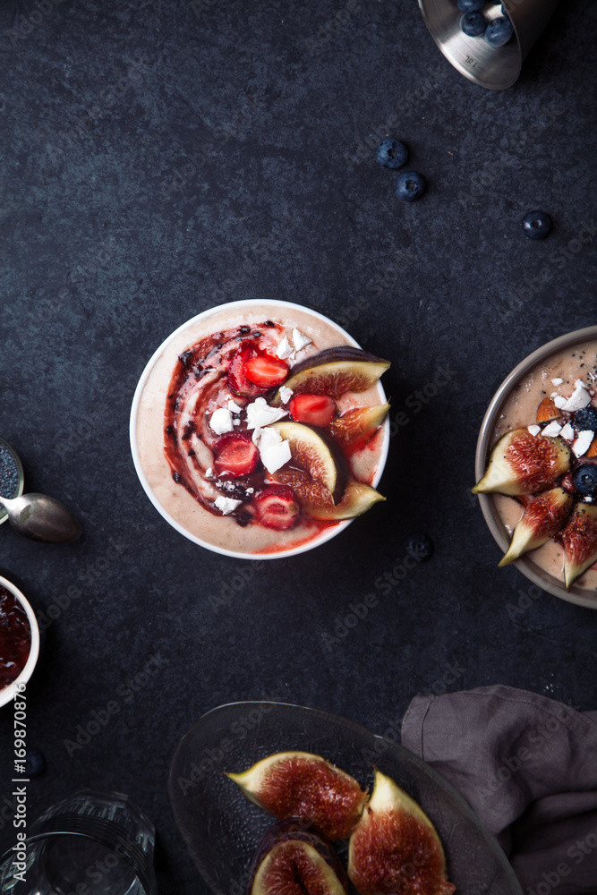 Almond milk bowl with strawberries and figs. Dark food phorography concept. Flatlay with copy space Almond milk bowl with strawberries and figs. Dark food phorography concept. Flatlay with copy space