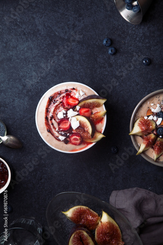 Almond milk bowl with strawberries and figs. Dark food phorography concept. Flatlay with copy space