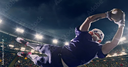 American football player jumps with a ball