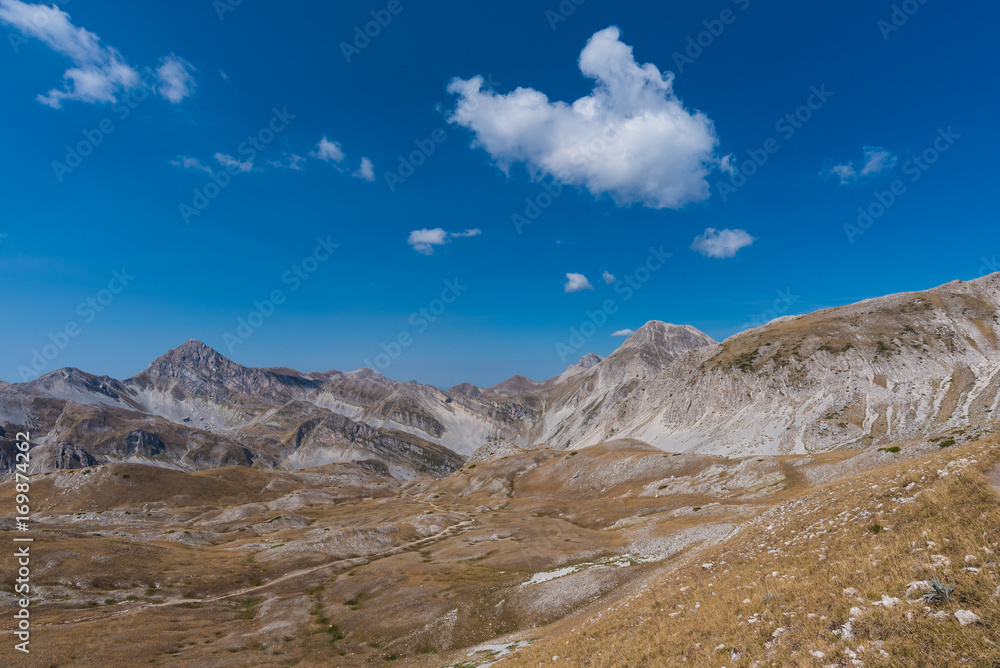 A high mountain range with peaks and plateaus on a warm summer day
