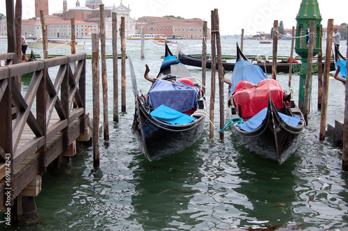 two gondolas docked at the pier near San Marco, Venice, Italy © mhgstan