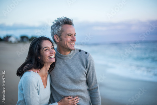 Portrait of a couple walking on the beach photo