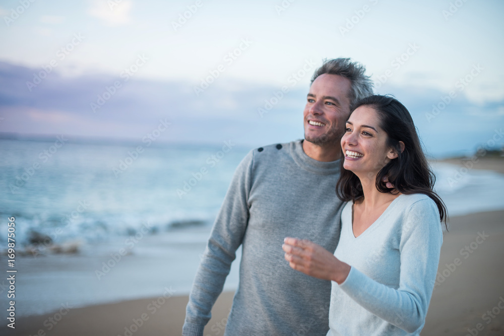 Portrait of a couple walking on the beach Portrait of a couple walking on the beach